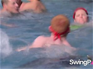 insane redheads play with different topless dolls by the pool